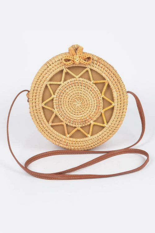 Bamboo Round Crossbody Bag with a brown leather strap and a woven star pattern on the front