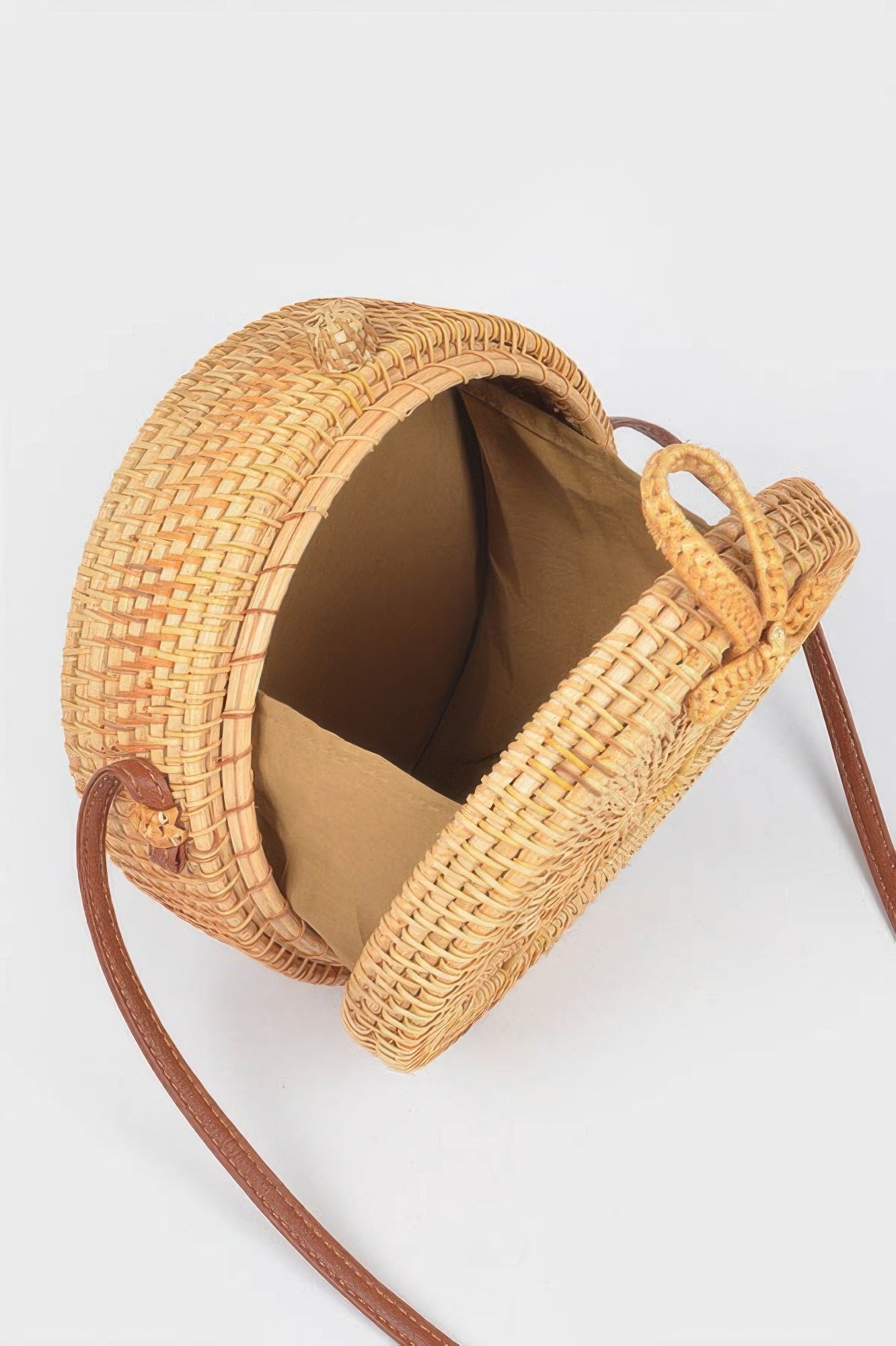Bamboo Round Crossbody Bag, open to show the brown fabric lining and interior