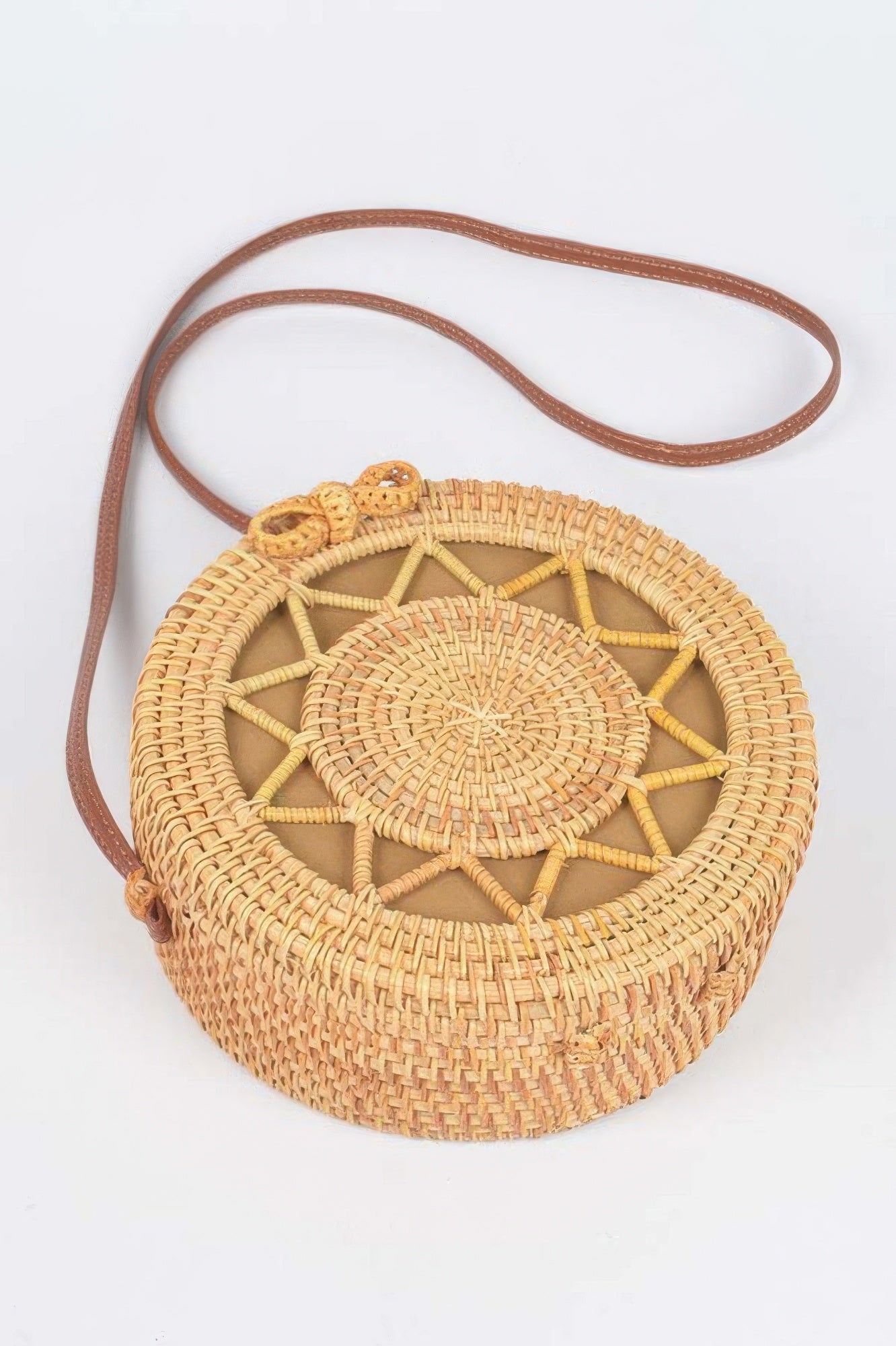 Bamboo Round Crossbody Bag with a brown leather strap and a woven pattern on the front