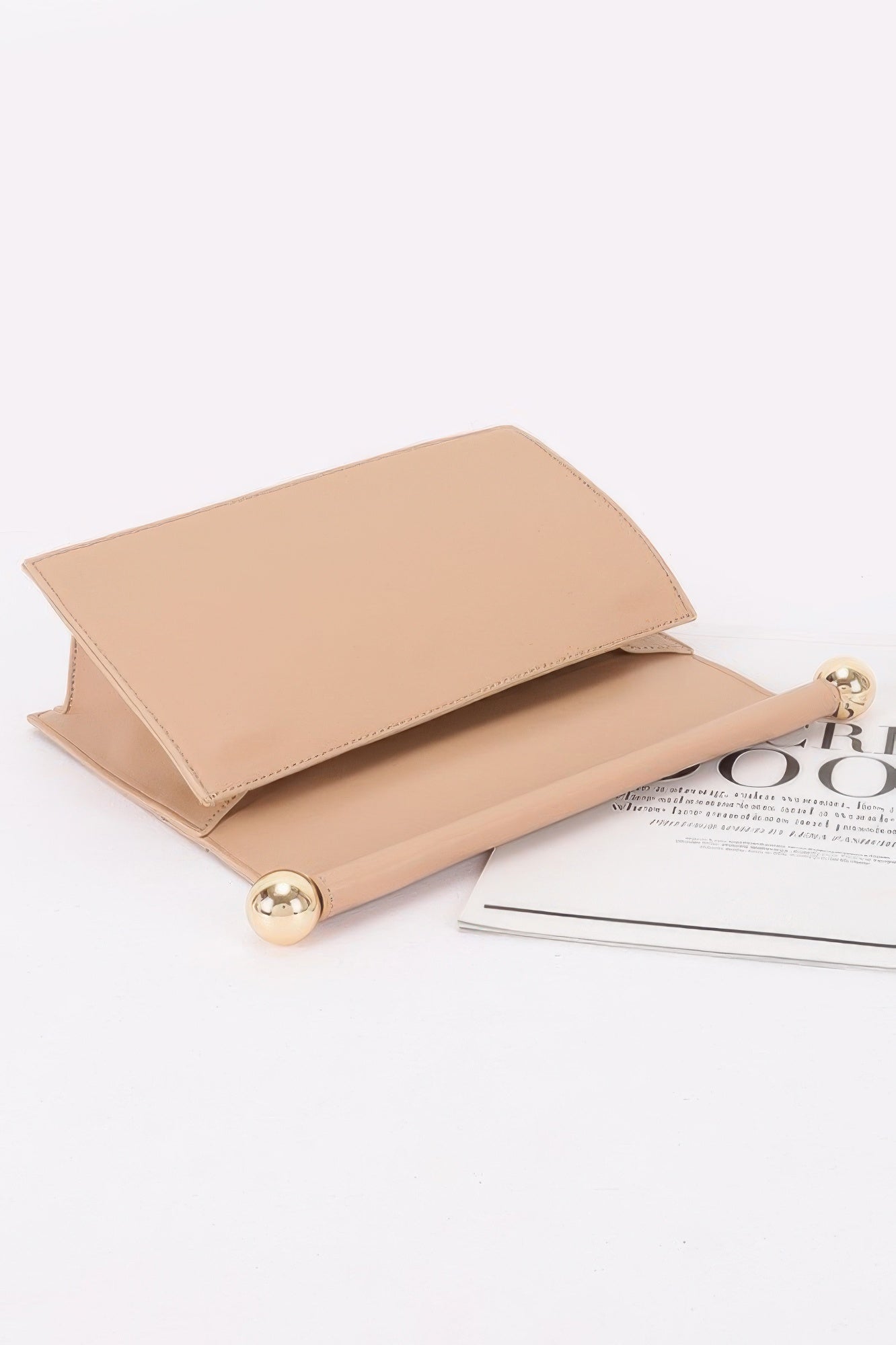 Roll-top Sphere Accent Chain Clutch in a light tan color with gold sphere accents