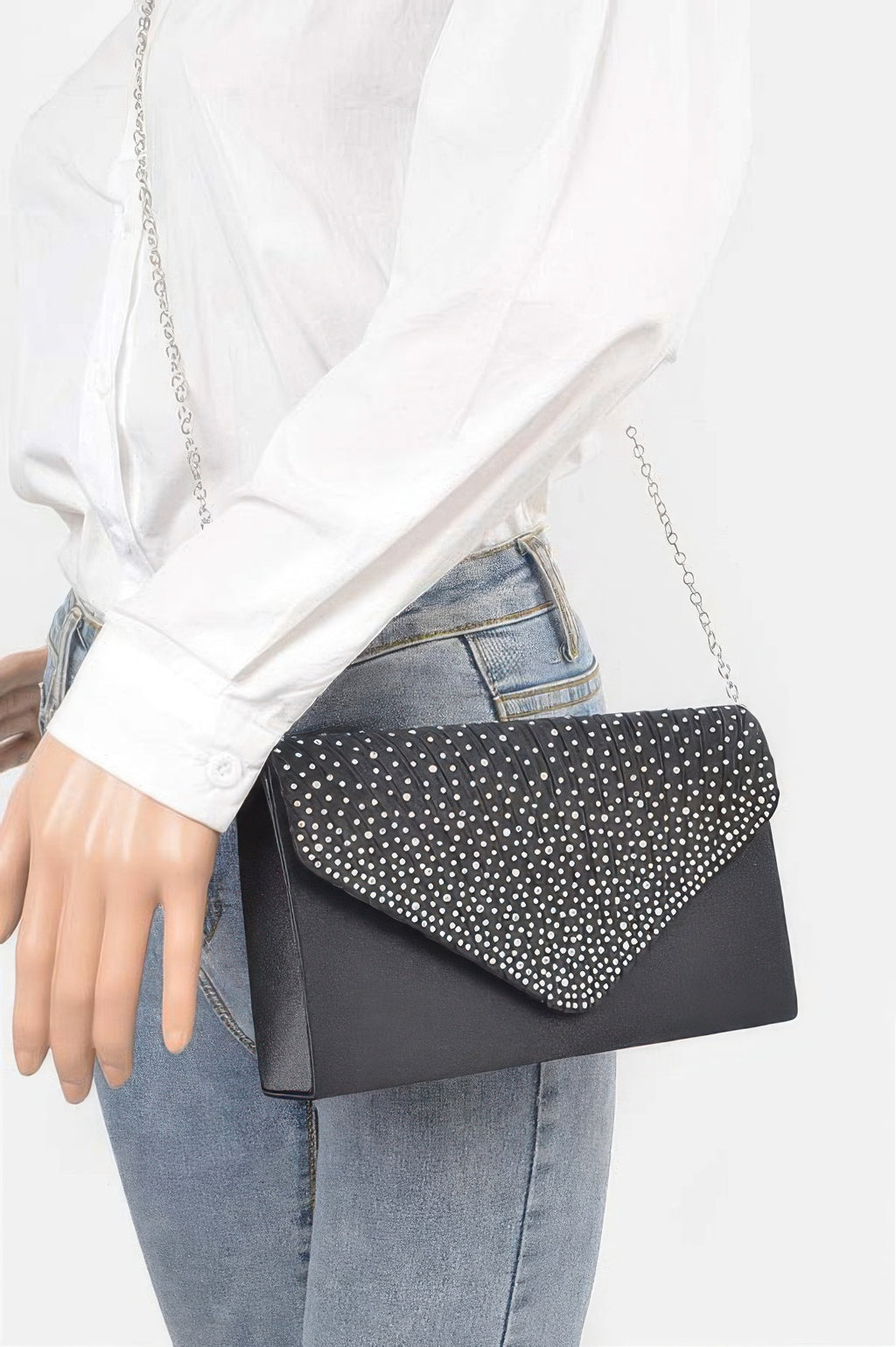 Rhinestone Satin Party Clutch in black with silver chain, worn by a person in a white shirt and jeans