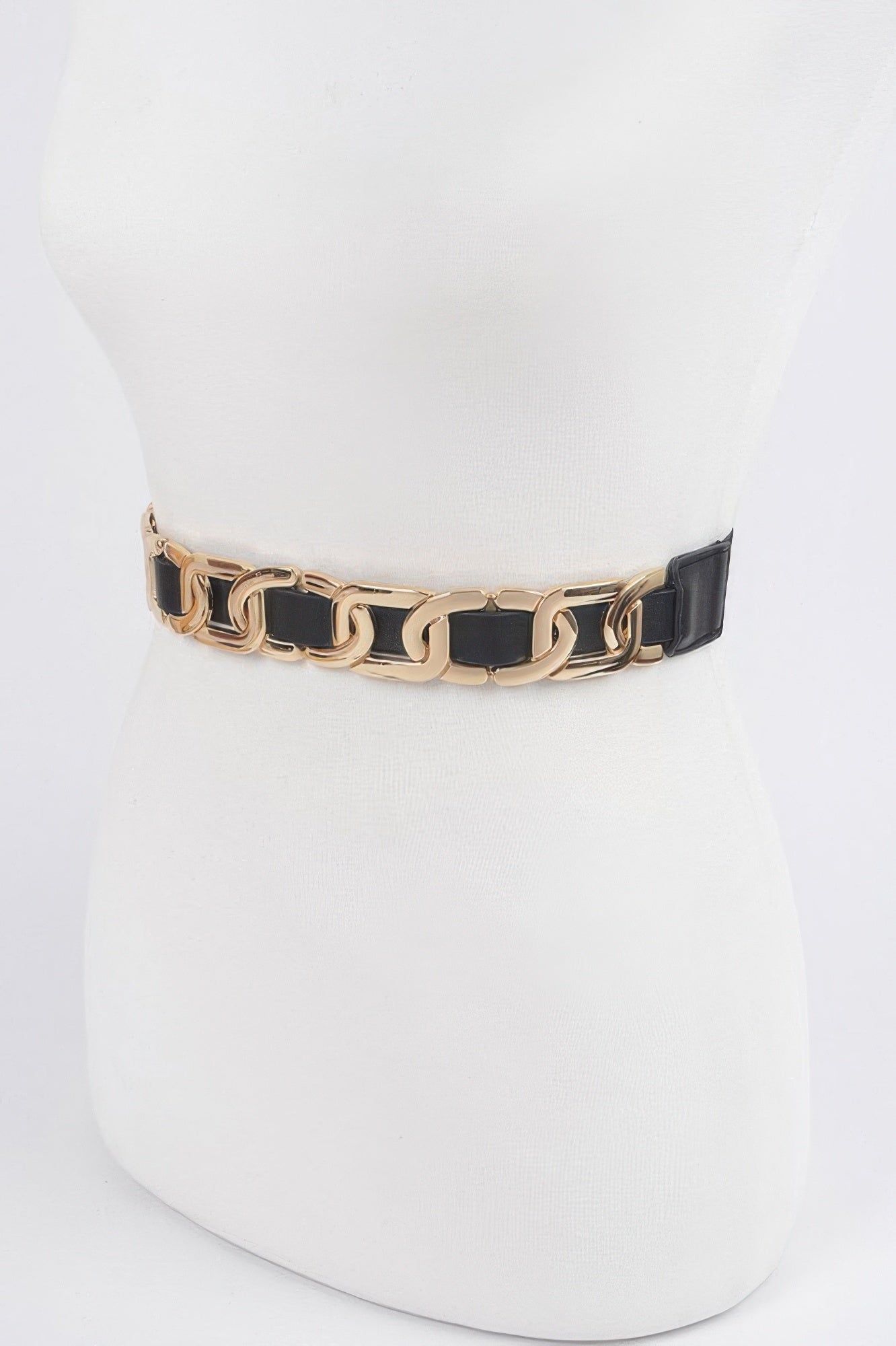 Multi Metal Stretch Belt with gold chain links and black faux leather woven through, on a white mannequin