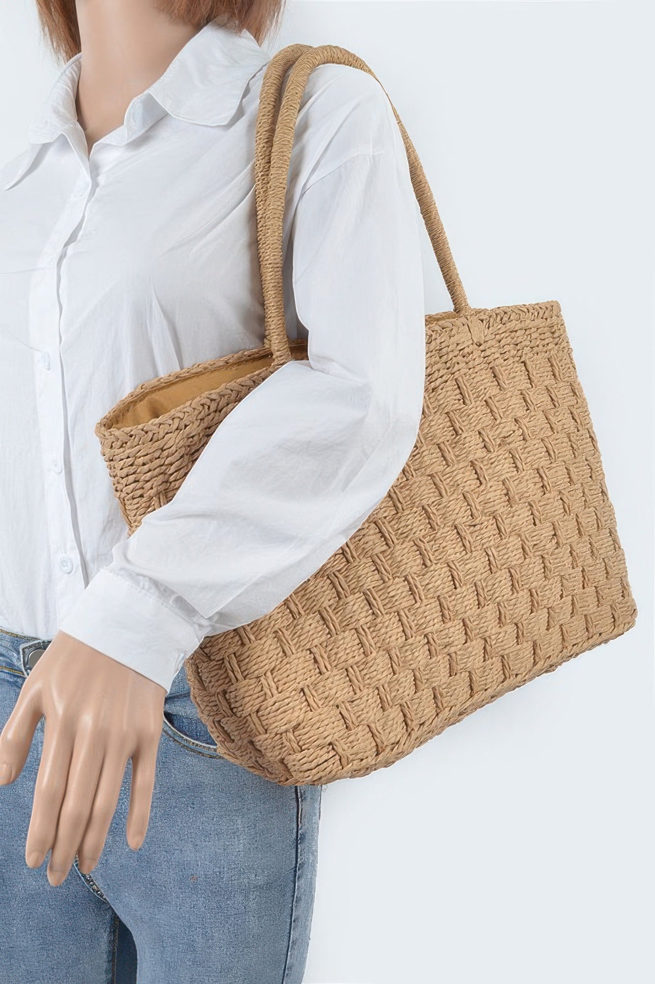 Straw Medium Tote Bag on a mannequin wearing a white shirt and blue jeans