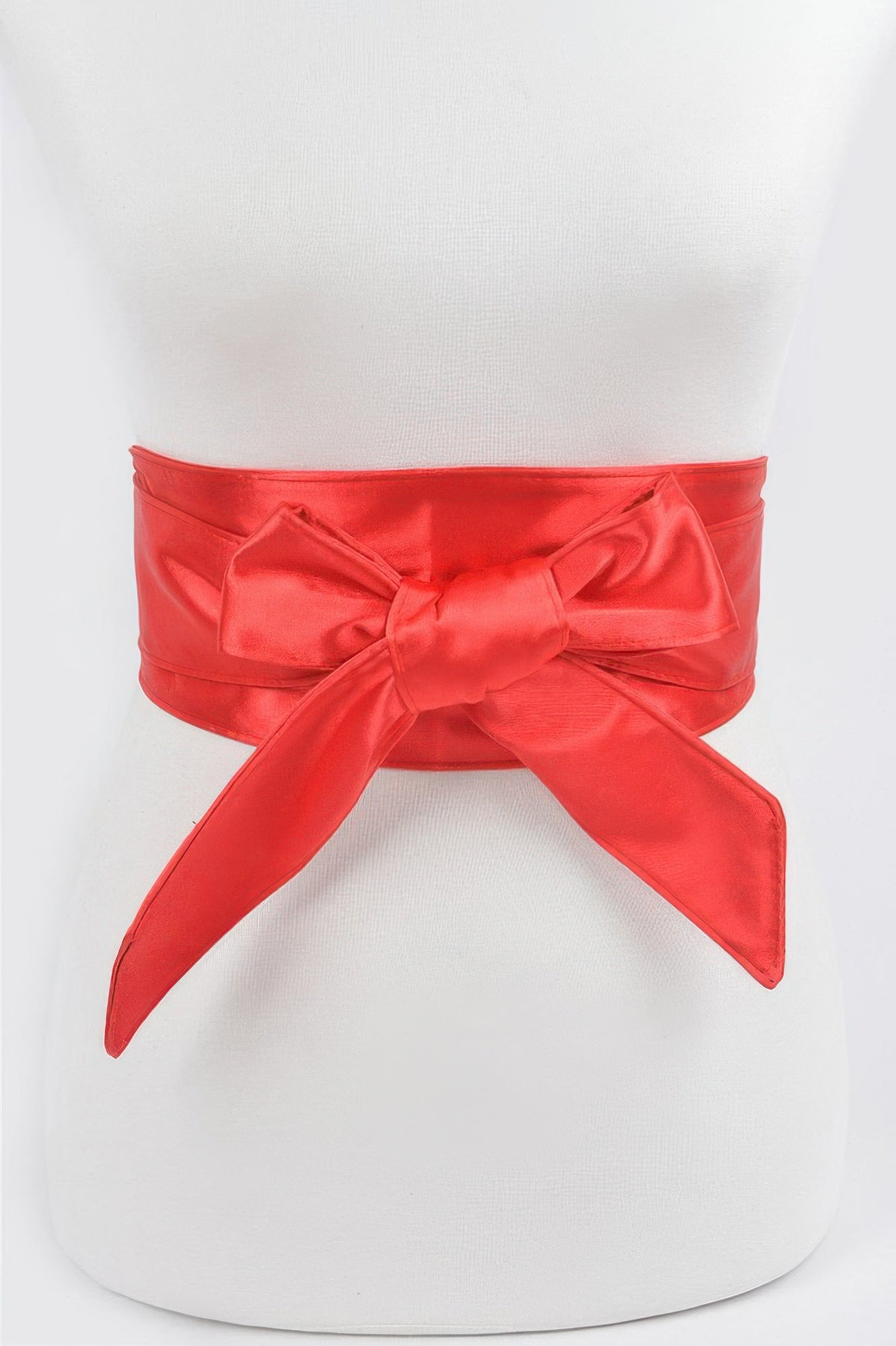 Red satin kimono belt tied in a bow around a white mannequin