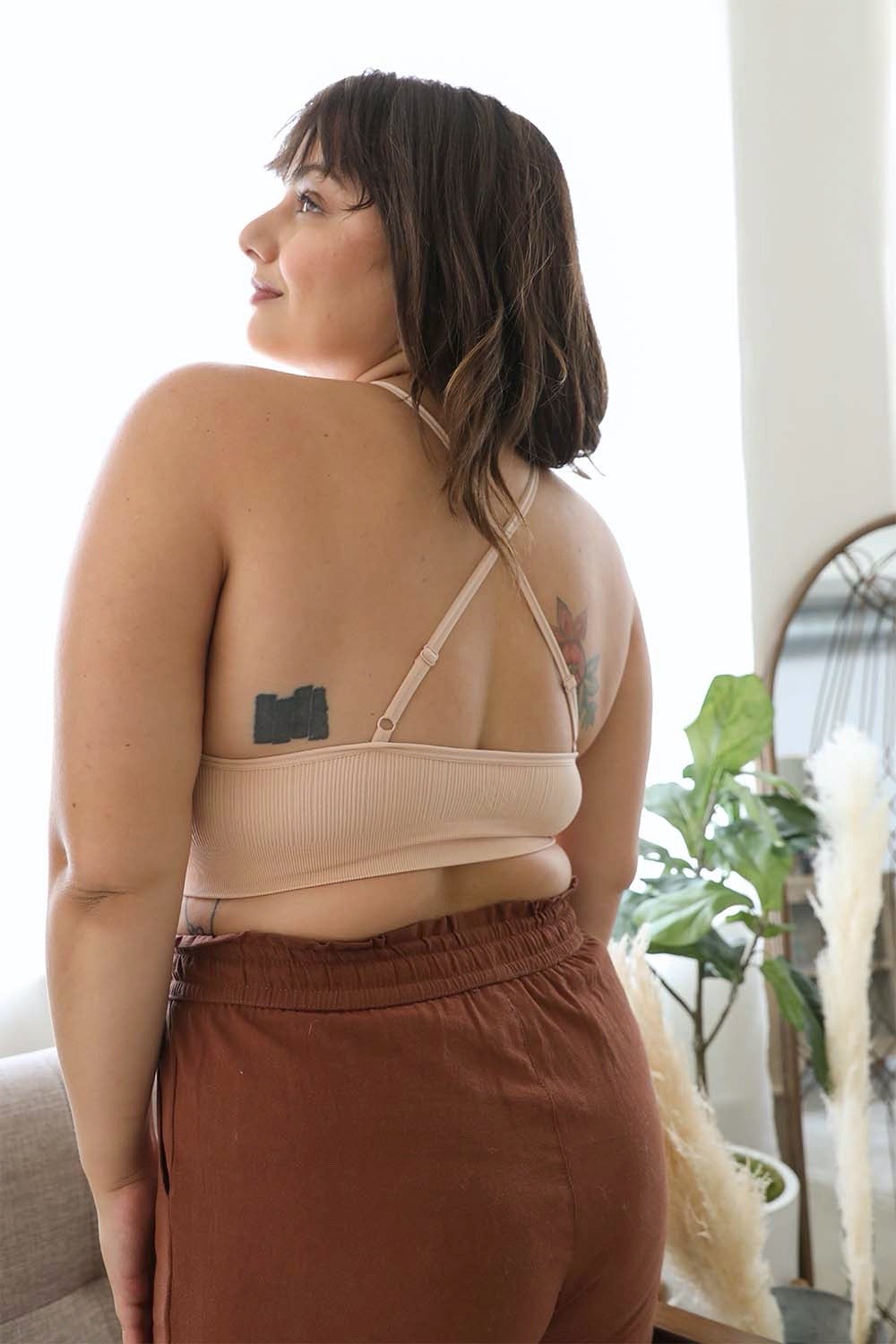 Woman from behind wearing a beige Crochet Lace High Neck Bralette with cross-back straps