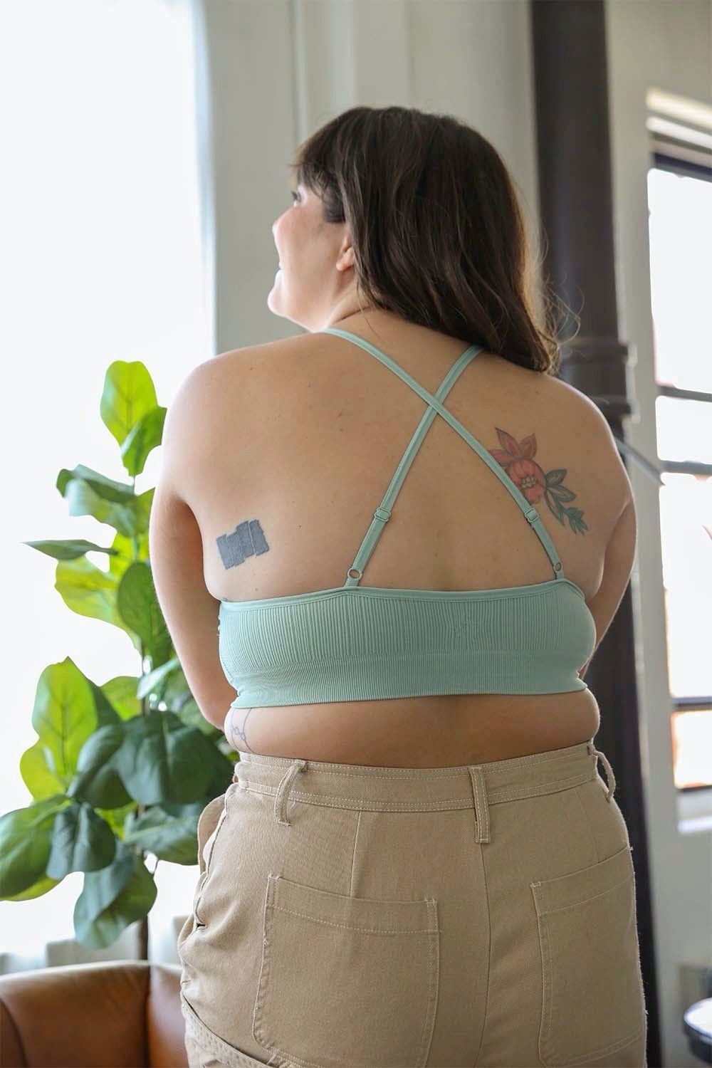 Woman from behind wearing a light green Crochet Lace High Neck Bralette with cross-back straps