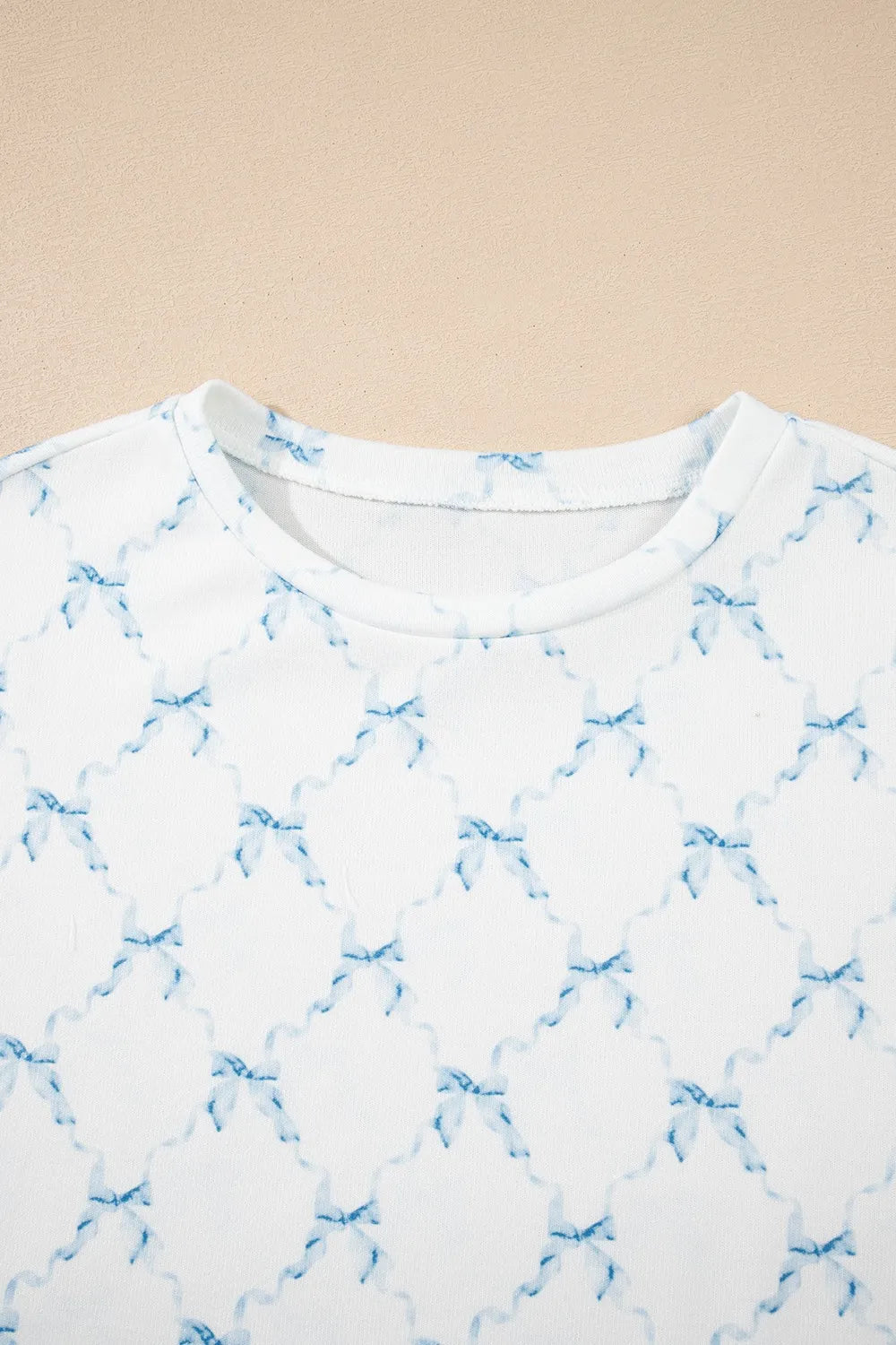 Close up of the Printed Round Neck Top and Shorts Two-Piece Lounge Set, showing the blue bow print