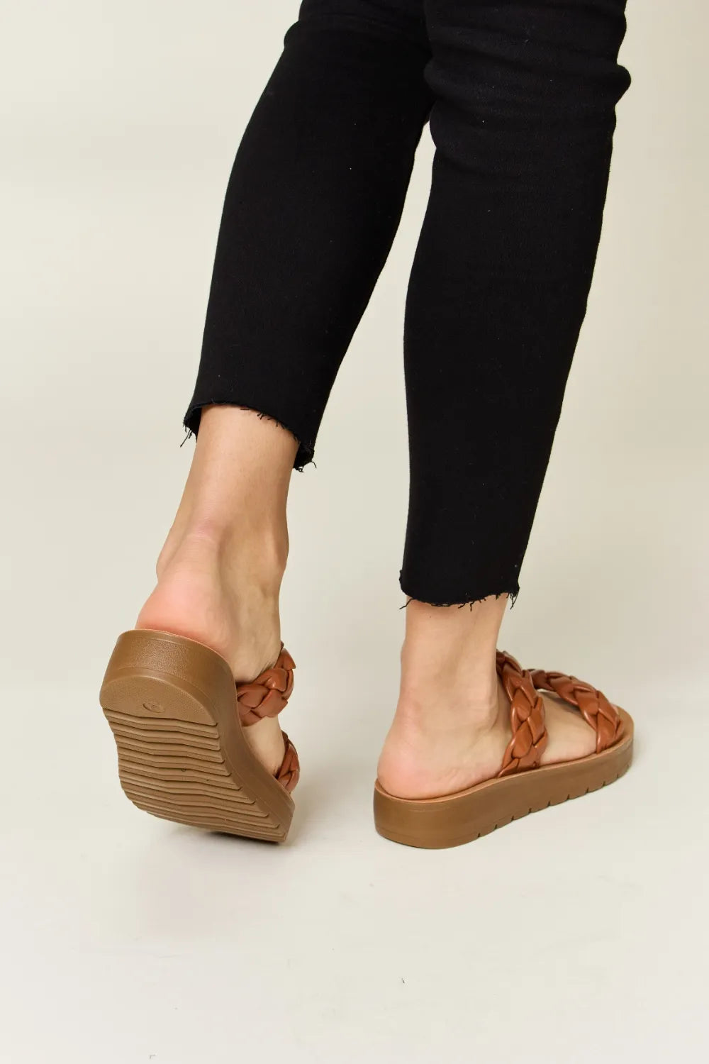 Woven Dual Band Platform Sandals in brown on a person wearing black pants