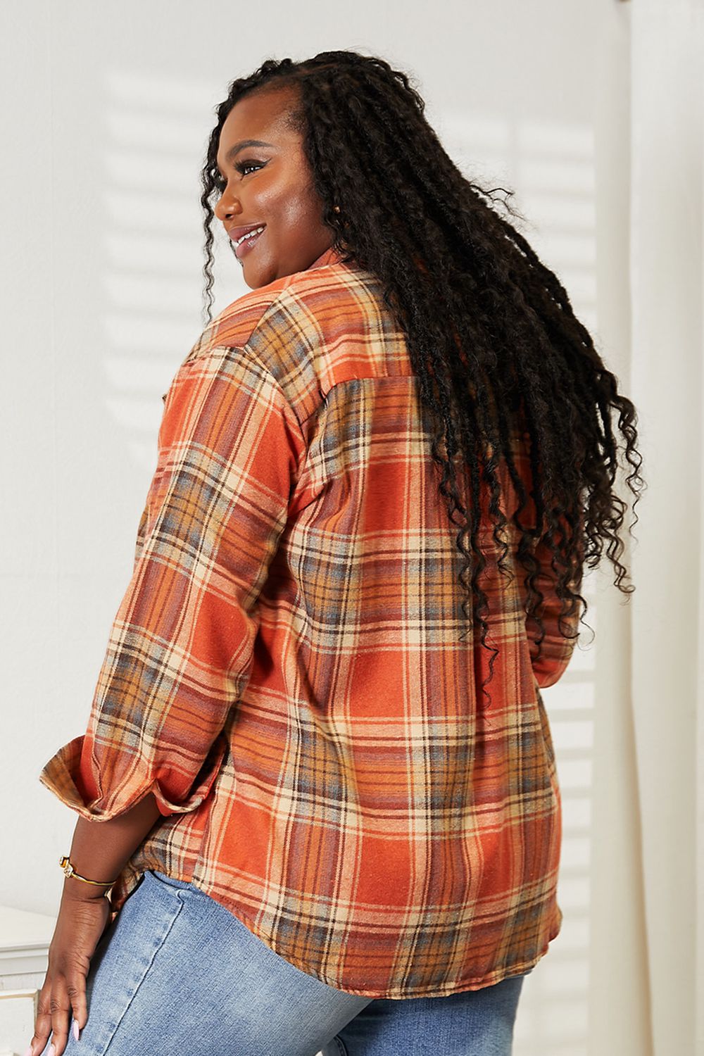 Plaid Button-Front Relaxed Shirt in orange, brown, and blue plaid, worn by a woman with long dark hair