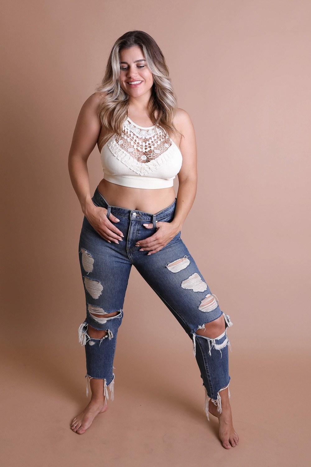 Crochet Lace High Neck Bralette, halter style with cross-back, paired with ripped jeans