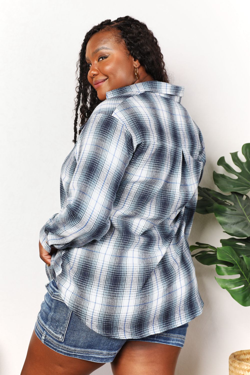 Woman in a Plaid Button-Front Relaxed Shirt and denim shorts, looking over her shoulder