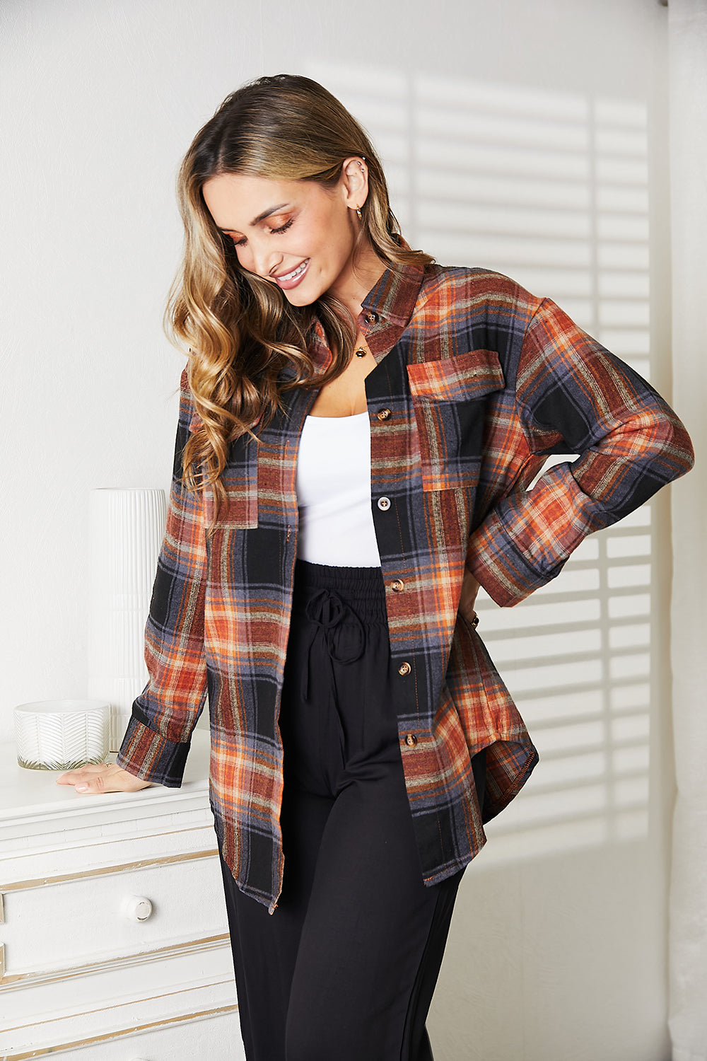 Plaid Button-Front Relaxed Shirt in orange, black, and blue plaid, worn by a woman with long hair