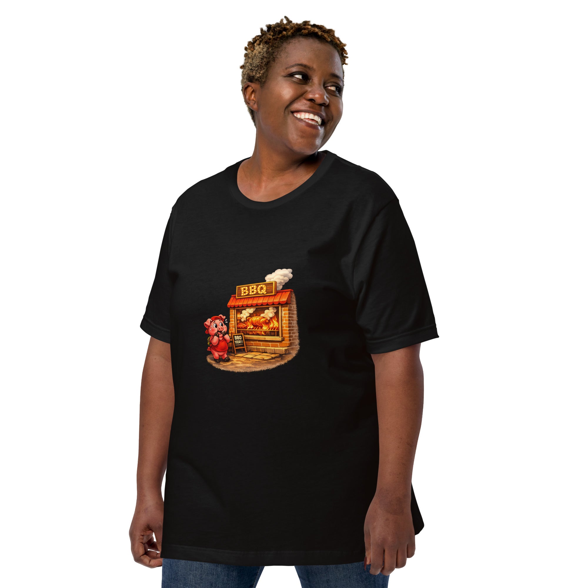 Woman wearing a black Pig & BBQ Graphic Tee with a cartoon pig next to a BBQ stand